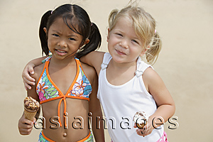 Asia Images Group - Young girls putting arms around each other