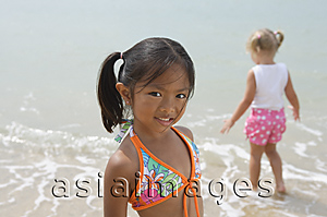 Asia Images Group - Two young girls playing at the beach
