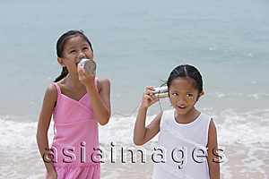 Asia Images Group - Young sisters playing with toy phones