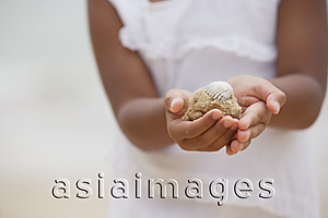 Asia Images Group - Close-up of girl holding sand with shell