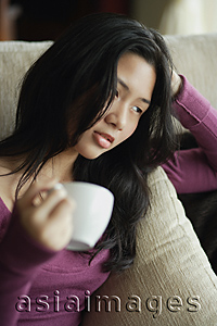 Asia Images Group - Young woman relaxing with cup of tea