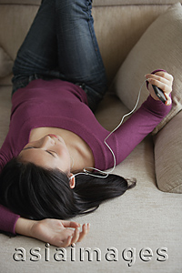 Asia Images Group - Young woman listening to music