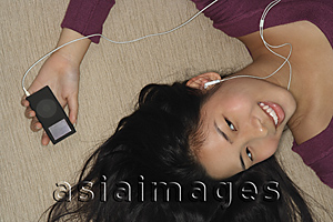 Asia Images Group - Young woman listening to music
