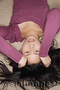 Asia Images Group - Young woman looking upside down at camera