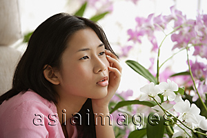 Asia Images Group - Young woman looking pensively into distance