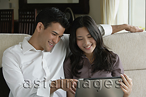 Asia Images Group - Young couple looking at laptop