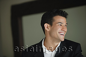 Asia Images Group - Young man laughing while looking sideways