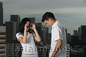 Asia Images Group - Woman taking picture of man