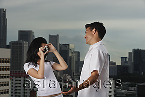 Asia Images Group - Woman taking picture of man