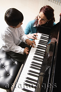 Asia Images Group - Piano teacher with little boy playing piano
