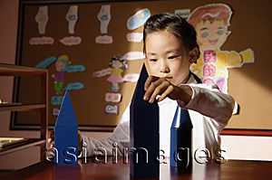 Asia Images Group - Schoolgirl with building blocks