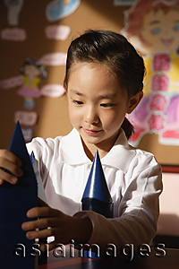 Asia Images Group - Schoolgirl with building blocks