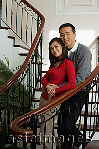 Asia Images Group - Young couple on stairs smiling at camera