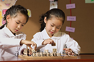 Asia Images Group - Schoolgirls in class playing with blocks