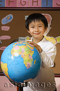 Asia Images Group - Schoolboy with globe