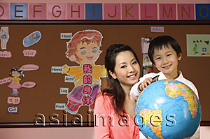 Asia Images Group - Schoolboy with teacher and globe