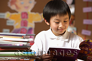 Asia Images Group - Schoolboy reading book