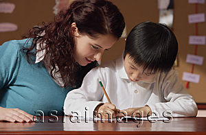 Asia Images Group - Teacher helping young student