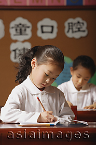 Asia Images Group - Schoolgirls in class writing