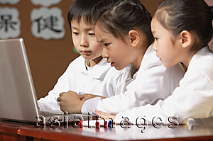 Asia Images Group - Young students using laptop in class