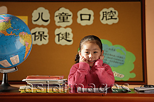 Asia Images Group - Girl sitting in class, looking at camera