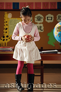 Asia Images Group - Student with apple in class