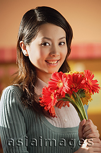 Asia Images Group - Young woman with flowers