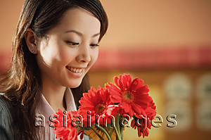 Asia Images Group - Young woman with flowers