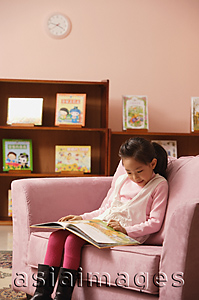 Asia Images Group - Young girl reading a book