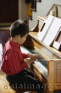 Asia Images Group - Little boy playing piano