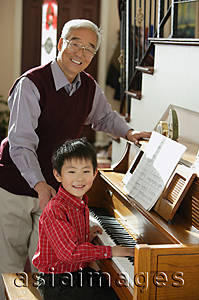 Asia Images Group - Boy playing piano for grandfather