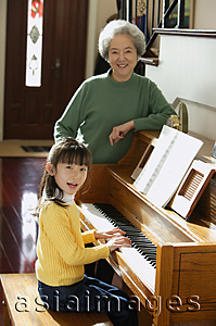 Asia Images Group - Girl playing piano for grandmother