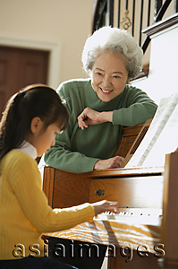 Asia Images Group - Girl playing piano for grandmother