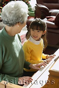 Asia Images Group - Girl playing piano with grandmother