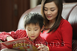 Asia Images Group - Mother and son looking at children's book