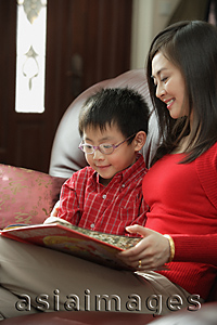 Asia Images Group - Mother and son looking at children's book