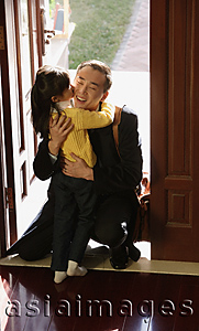 Asia Images Group - Girl greeting father at door