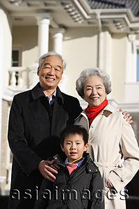 Asia Images Group - Elderly couple with grandson smiling at camera