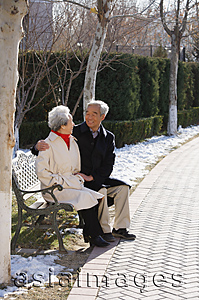 Asia Images Group - Elderly couple sitting on park bench
