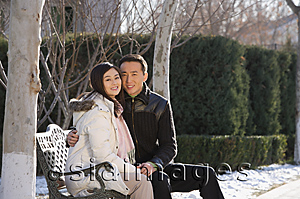 Asia Images Group - Young couple sitting on park bench