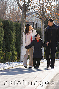 Asia Images Group - Young family walking in the park