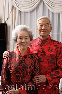 Asia Images Group - Elderly couple in traditional clothes smiling at camera