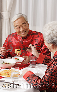 Asia Images Group - Elderly couple in traditional clothing at dinner table