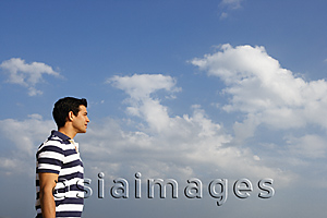 Asia Images Group - Young man looking at the sky