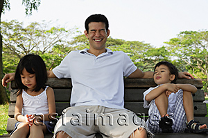 Asia Images Group - Father and children on park bench