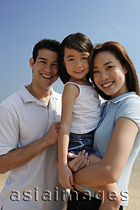 Asia Images Group - Young parents with daughter, looking at camera
