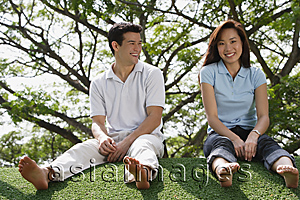 Asia Images Group - Young couple sitting on ground at the park