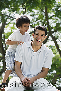 Asia Images Group - Father sitting with son at the park