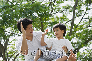 Asia Images Group - Father and son playing at the park