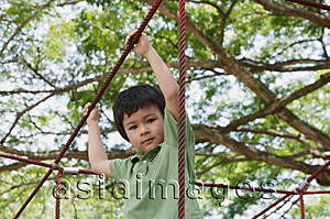 Asia Images Group - Young boy playing at the park, looking at camera